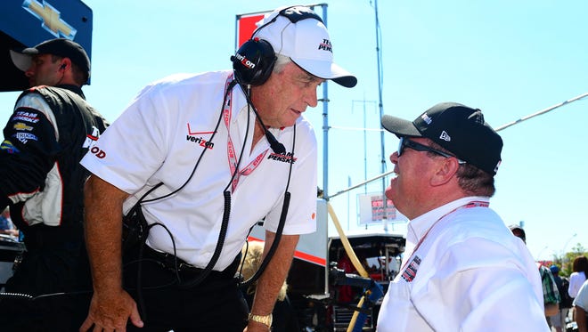 Roger Penske talks with fellow team owner Chip Ganassi before the Honda Indy Toronto in 2013. Penske and Ganassi are rivals at the top levels of IndyCar, NASCAR and sports cars. Penske has 16 Indy 500 wins to Ganassi's four.