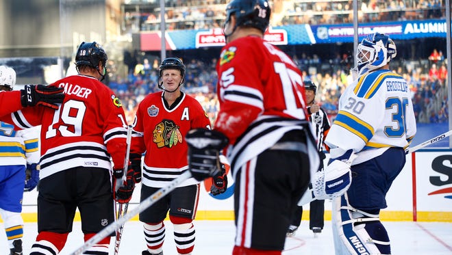 Former St. Louis Blues goalie Martin Brodeur, right, looks on as former Chicago Blackhawks' Kyle Calder, Reggie Kerr, second from left, and Jim Cummins celebrate after scoring a goal during the winter classic alumni outdoor game at Busch Stadium on Dec. 31, 2016.