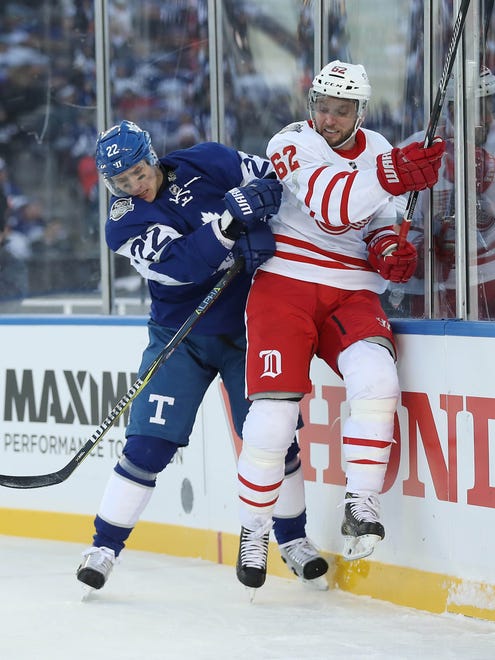 Toronto Maple Leafs defenseman Nikita Zaitsev (22) hits Detroit Red Wings left wing Thomas Vanek (62) during the Centennial Classic ice hockey game at BMO Field. Mandatory Credit: Tom Szczerbowski-USA TODAY Sports