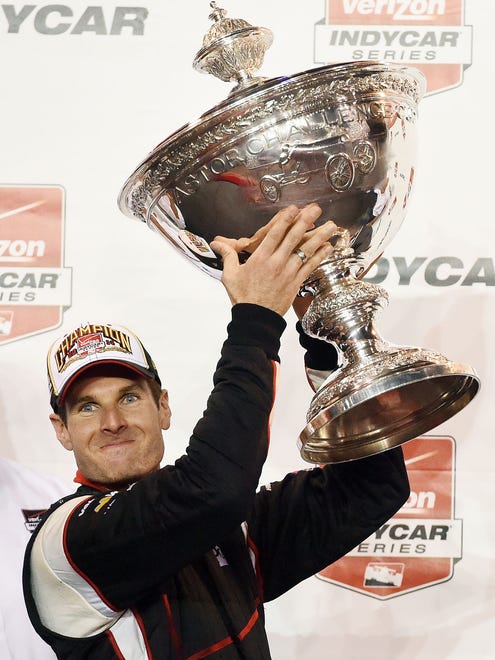 Will Power holds the Astor Cup after winning the 2014 IndyCar Series season championship Aug. 30, 2014. It was Penske's 13th title in open wheel.