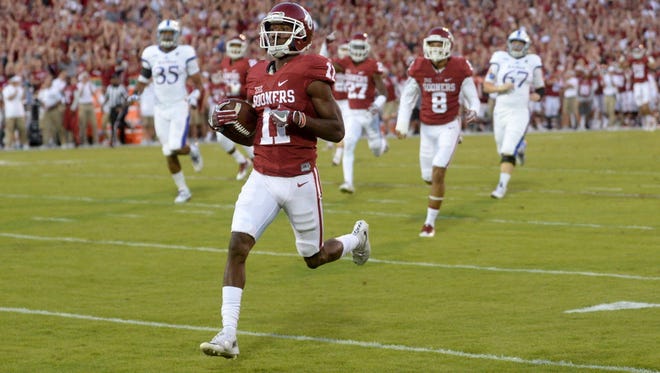 Oklahoma wide receiver Dede Westbrook (11) returns a punt for a touchdown against Kansas.