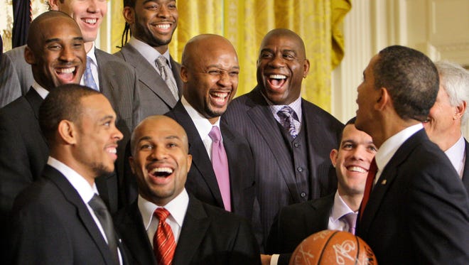 President Barack Obama shares a laugh with members of the Los Angeles Lakers in the East Room of the White House in Washington, Monday, Jan. 25, 2010.