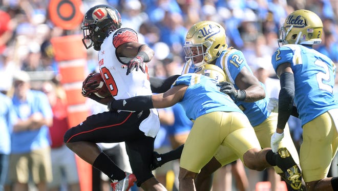 Utah Utes running back Joe Williams (28) runs the ball against the UCLA Bruins during the first half at the Rose Bowl.