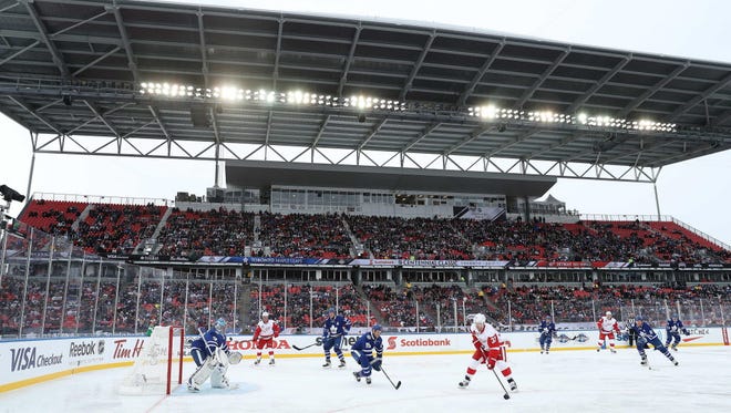 Red Wings forward Kris Draper (33) attacks with the puck against the Maple Leafs during the Centennial Classic Alumni Game.