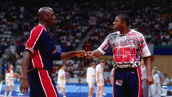 1992: Magic Johnson and Michael Jordan of the United States high five each other against Lithuania during the 1992 Olympics.