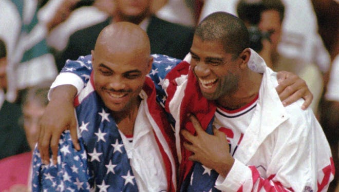 1992: USA's Charles Barkley, left, and Earvin "Magic" Johnson laugh together during the medal ceremony.