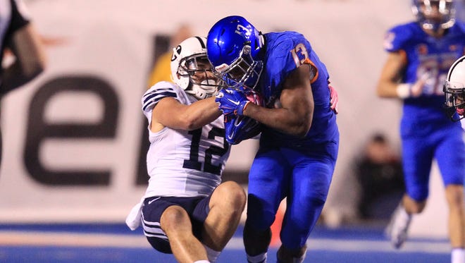 BYU defensive back Kai Nacua strips the ball from Boise State running back Jeremy McNichols at Albertsons Stadium.