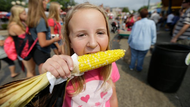 Ava Roberts, 10, from West Allis bites into an ear of corn. She was with with her aunt Catie Schachtely, also of West Allis.
