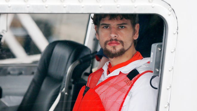 Nathan Carman arrives in a small boat at the U.S. Coast Guard station in Boston, Sept. 27, 2016. Carman spent a week at sea in a life raft before being rescued by a passing freighter.