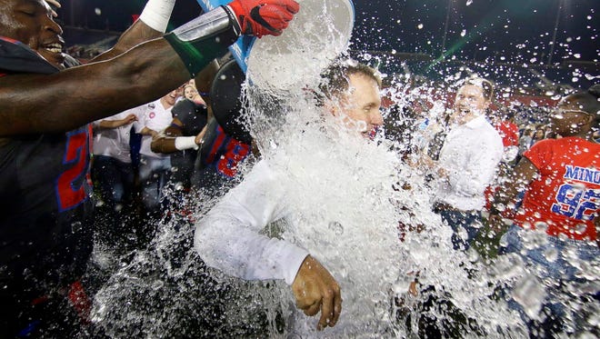 SMU head coach Chad Morris gets the water bath following the Mustangs, victory over Houston.