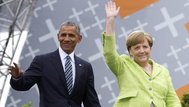 German Chancellor Angela Merkel and former president  Barack Obama arrive for a discussion on democracy at Church Congress on May 25, 2017 in Berlin, Germany.