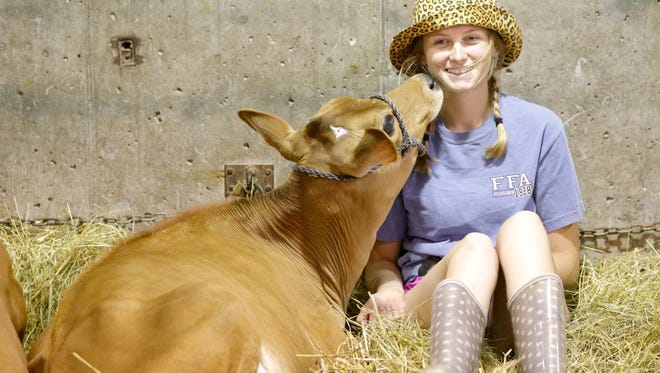 The 166th Wisconsin State Fair opened Thiursday and runs  through August 13 Crystal Cafferty, 17,  from Elroy, gets a kiss from her 7-month-old Jersey calf, Octave, in the cattle barn.