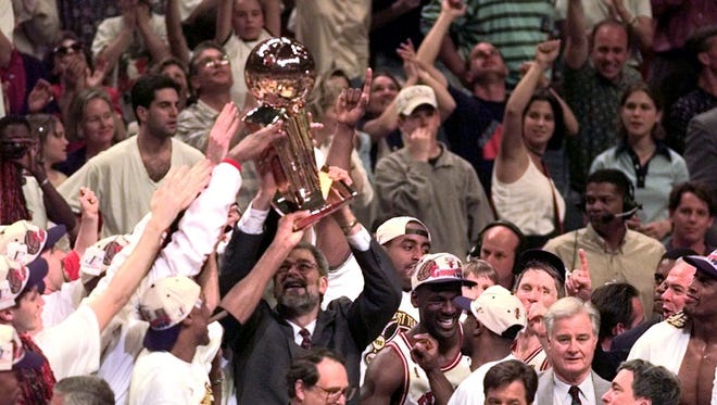 1996: Jackson and Michael Jordan celebrate after winning the championship.