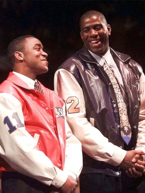 1997: Former Detroit Pistons' Isiah Thomas, left, jokes with Magic Johnson of the Los Angeles Lakers during halftime ceremonies of the NBA All-Star Game.