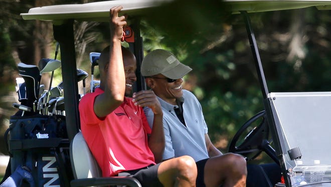 Ray Allen and President Barack Obama talk as they sit in a cart while golfing, Wednesday, Aug. 12, 2015, at Farm Neck Golf Club, in Oak Bluffs, Mass., on the island of Martha's Vineyard.