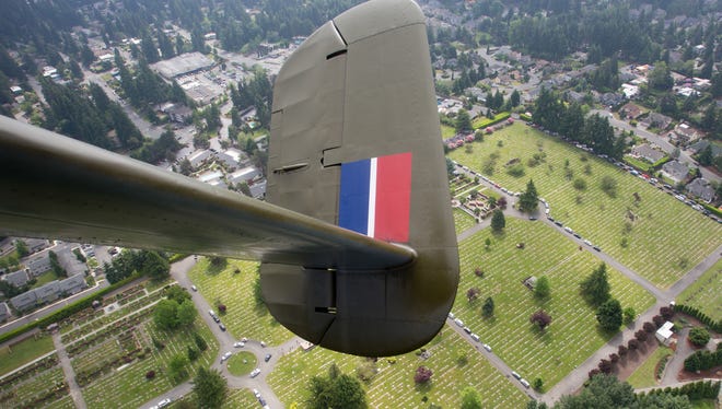 A Memorial Day cemetery service underway receives a flyover from Historic Flight Foundation's World War II-era B-25 bomber during a special Memorial Day flight on May 29, 2017.