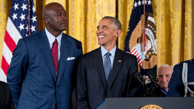President Barack Obama, reacts as NBA legend Michael Jordan playfully looms over him at a Presidential Medal of Freedom ceremony in the East Room of the White House, Tuesday, Nov. 22, 2016, in Washington.