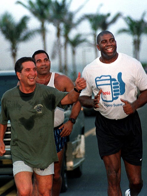 1998: Puerto Rican Governor Pedro Rossello, left, waves as he jogs with NBA star Magic Johnson, right, through the streets of Old San Juan, Puerto Rico.