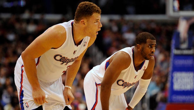 2013: Los Angeles Clippers guard Chris Paul (3) and Los Angeles Clippers forward Blake Griffin (32) rest during a break in play.