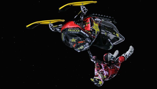JANUARY 27:  Colten Moore kicks off the sled as he goes inverted doing a flip across a jump during the Snowmobile Freestyle elimination rounds at Winter X Games 15 on Buttermilk Mountain on January 27, 2011 in Aspen.