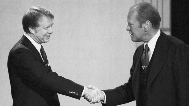 President Gerald Ford, right, and Jimmy Carter shake hands before their debate at the Palace of Fine Arts Theatre on Oct. 6, 1976, San Francisco.