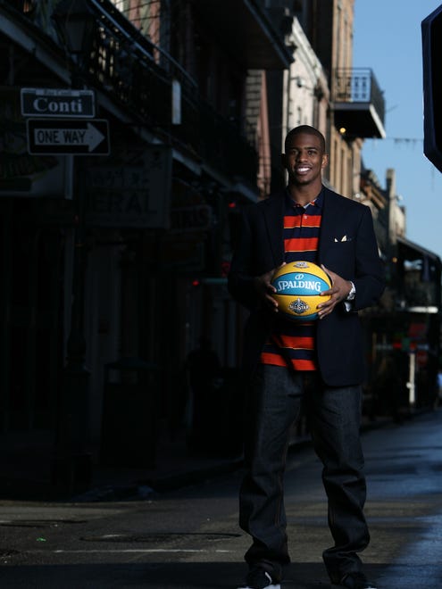 2008: Chris Paul holds the official NBA All Star basketball while standing on Bourbon St. in the French Quarter.