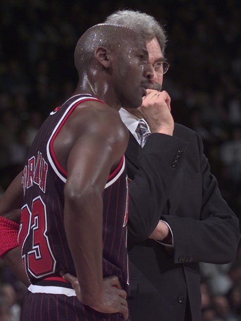 1997: Michael Jordan talks to Jackson during a break against the Los Angeles Lakers.