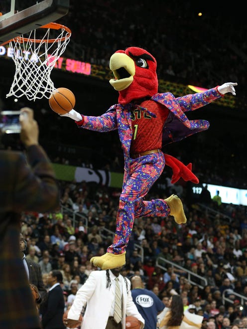 Atlanta Hawks mascot Harry the Hawk wears a suit inspired by the late Craig Sager as he performs during a break in the fourth quarter of their game against the Charlotte Hornets at Philips Arena.