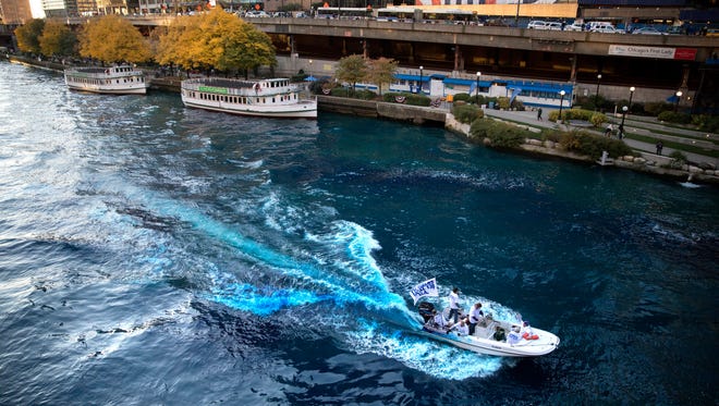 The Chicago River is dyed blue near the Michigan Avenue Bridge.
