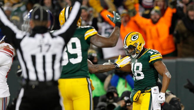 Green Bay Packers wide receiver Randall Cobb (18) celebrates after scoring on a touchdown reception against the New York Giants during the second quarter in the NFC Wild Card playoff football game at Lambeau Field.