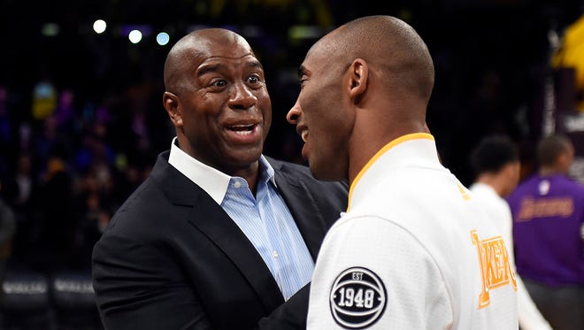 2016: Los Angeles Lakers forward Kobe Bryant (24) and Los Angeles Lakers former player Magic Johnson talk before the game against the Charlotte Hornets.