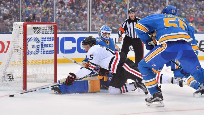 Chicago Blackhawks center Artem Anisimov (15) shoots wide of St. Louis Blues goalie Jake Allen (34) during the third period in the 2016 Winter Classic.