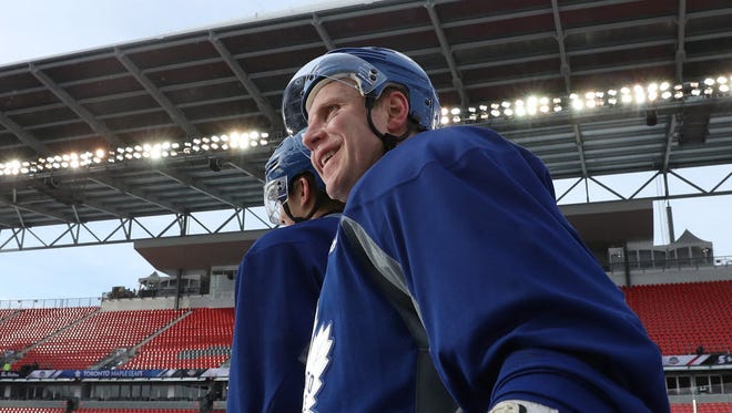Maple Leafs center Leo Komarov (47) smiles during practice for the Centennial Classic.