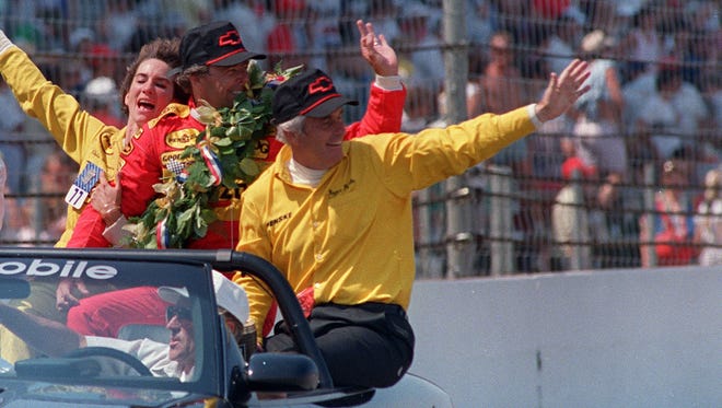 Rick Mears, second from right, team owner Roger Penske, right, and their wives, Kathy Penske, left, and Chris Mears, second from left, celebrate as they take a victory lap after the 72nd running of the Indianapolis 500. This was Mears' third of a record-tying four wins in IndyCar's premier event.