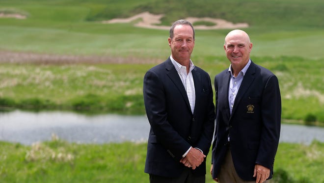 Erin Hills owner Andy Ziegler and  U.S. Open chairman Jim Reinhart, a friend of Ziegler's from Mequon, pose for  a photo on the fairway of the first hole before playing a round of golf during U.S. Open media day recently.