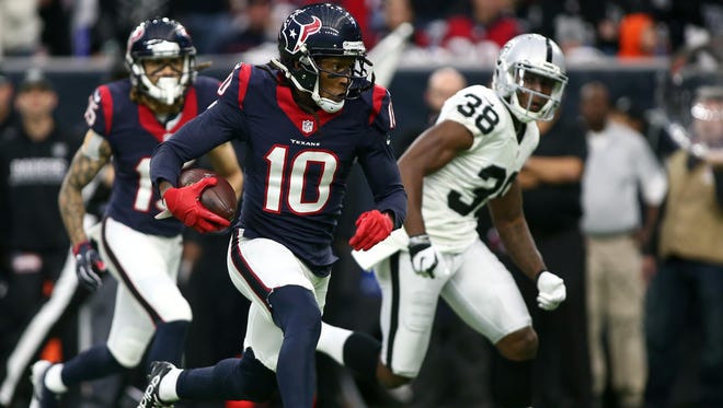 Houston Texans wide receiver DeAndre Hopkins (10) runs the ball during the first half of the AFC Wild Card playoff football game against the Oakland Raiders at NRG Stadium.