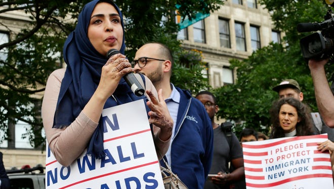 Yemeni American Wadid Hassan speaks to supporters who gathered to protest a travel ban in Union Square, June 29, 2017, in New York. A scaled-back version of President Donald Trump's travel ban takes effect Thursday evening, stripped of provisions that brought protests and chaos at airports worldwide in January yet still likely to generate a new round of court fights.