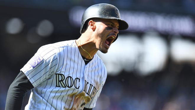 Sept. 30: The Colorado Rockies' Nolan Arenado reacts after hitting a two-run home run against the Washington Nationals in the first inning at Coors Field. The Rockies won the game, 12-0.