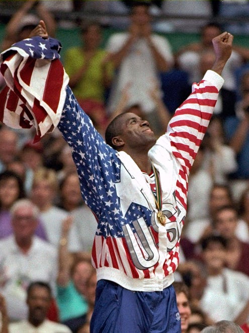 1992: USA's Earvin "Magic" Johnson rejoices with his gold medal after beating Croatia 117-85 in the gold medal game.