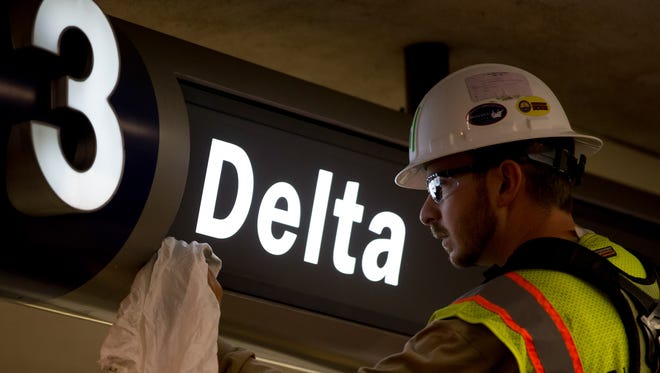 A worker polishes off a newly-installed sign at Terminal 3 at Los Angeles International Airport on May 13, 2017 during a major relocation effort that saw 15 airlines shifting in five nights.