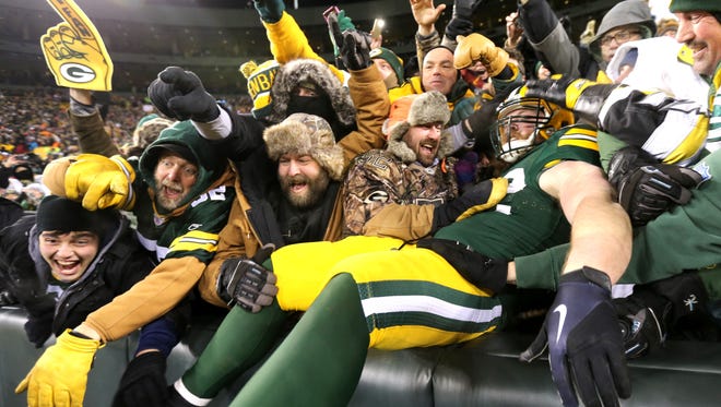 Green Bay Packers fullback Aaron Ripkowski (22) celebrates with the Lambeau Leap after scoring a touchdown against the New York Giants in the fourth quarter in the NFC Wild Card playoff football game at Lambeau Field.