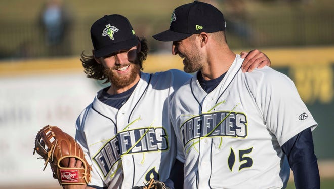 April 6: Tim Tebow talks with teammate Gene Cone before the team's minor league game.