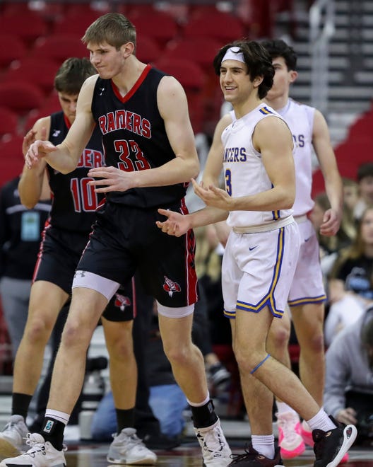 Marathon High School's Grant Warren (33) and Kenosha St. Joseph Catholic Academy's Eric Kenesie (3) react after Kenesie is called for a travel in a Division 4 semifinal game during the WIAA state boys basketball tournament on Thursday, March 14, 2024 at the Kohl Center in Madison, Wis. Kenosha St. Joseph Catholic won the game, 46-37.