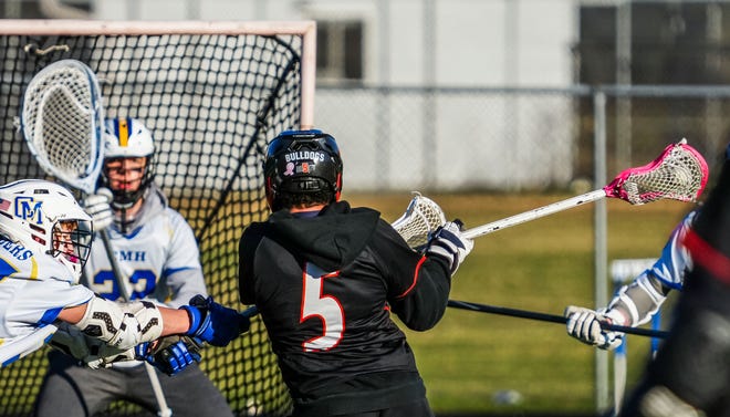 Cedarburg's Keller Hinkson (5) takes a shot on goal during the lacrosse match at Catholic Memorial on Wednesday, March 20, 2024. Cedarburg won 6-5.