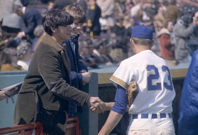 Brewers pitcher Bob Locker shakes hands with a fan during the Brewers' first opening day on April 7, 1970. It was also the season opener for the Brewers. A crowd of 37,237 saw the Brewers fall to the California Angels 12-0.