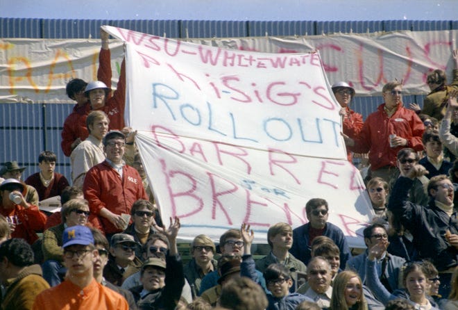 Fans from Whitewater fraternity hold up a sign that says "WSU-Whitewater Phi-Sig's rollout barrel for Brewers" during the Brewers' first opening day on April 7, 1970. The game was also the season opener for the Brewers. A crowd of 37,237 saw the Brewers fall to the California Angels 12-0.