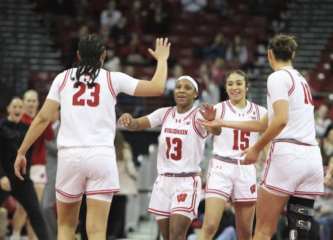 Ronnie Porter (13) and Sania Copeland (15) celebrates with D'Yanis Jimenez (23) and Halle Douglass (10) during a WNIT game at the Kohl Center in Madison, Wisconsin on Thursday March 28, 2024.