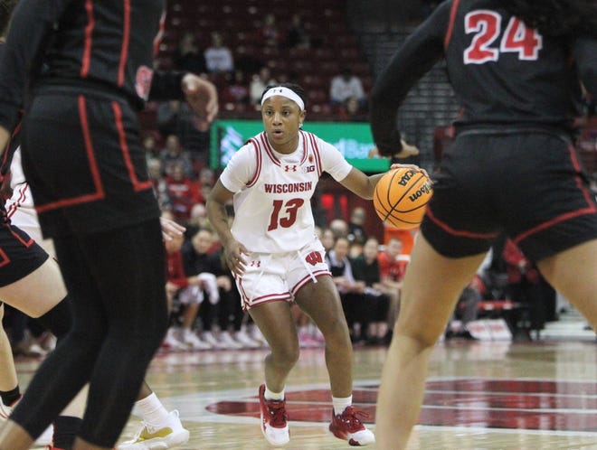 Wisconsin's Ronnie Porter (13) handled the ball during a WNIT game at the Kohl Center in Madison, Wisconsin on Thursday March 28, 2024.