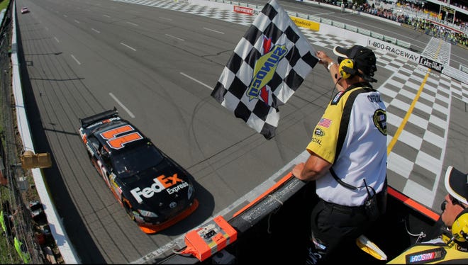 Denny Hamlin takes the checkered flag for the Red Cross Pennsylvania 500 on Aug. 3, 2009, marking the third time Hamlin had won at Pocono Raceway since his Cup debut.