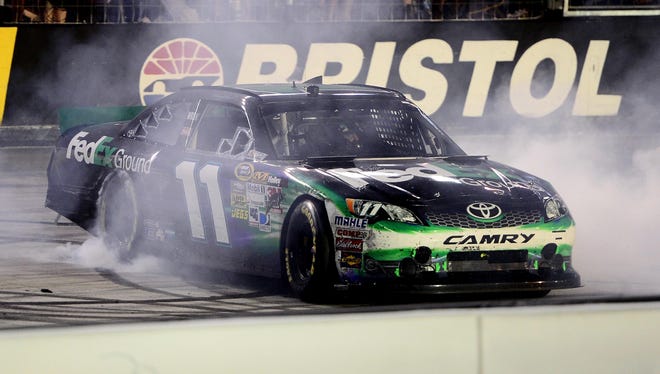 Denny Hamlin does a burnout after winning the IRWIN Tools Night Race a Bristol Motor Speedway on Aug. 25, 2012.